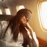 Pacific Islander businesswoman sleeping on private jet